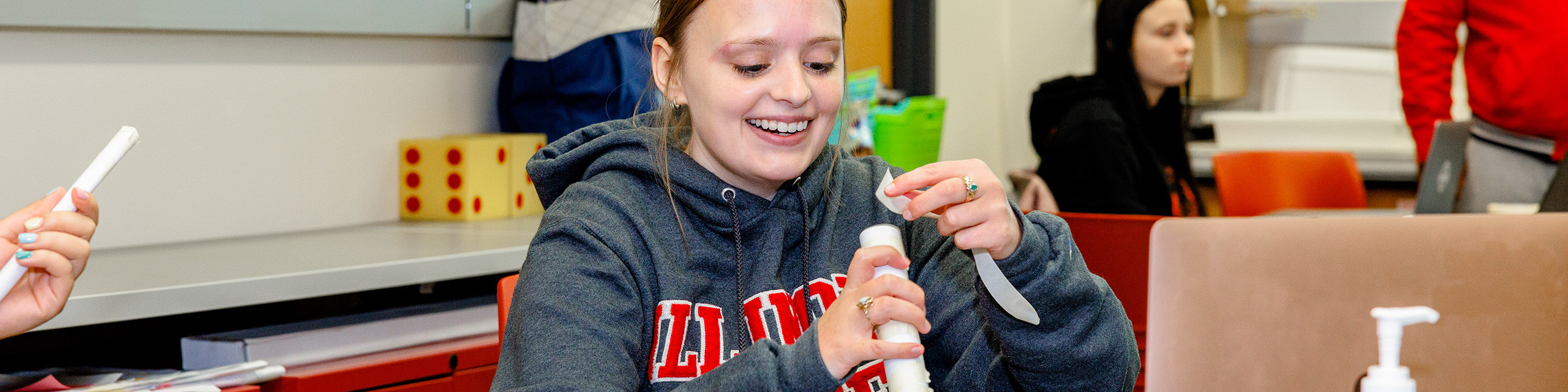 A student in a classroom working on a project